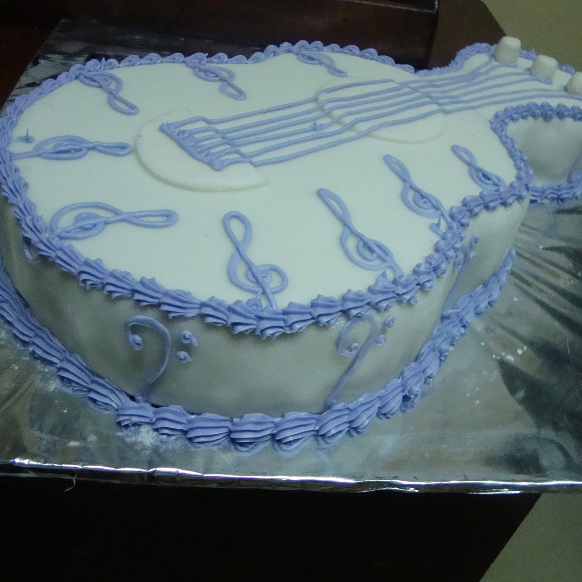 Guitar shaped celebration cake