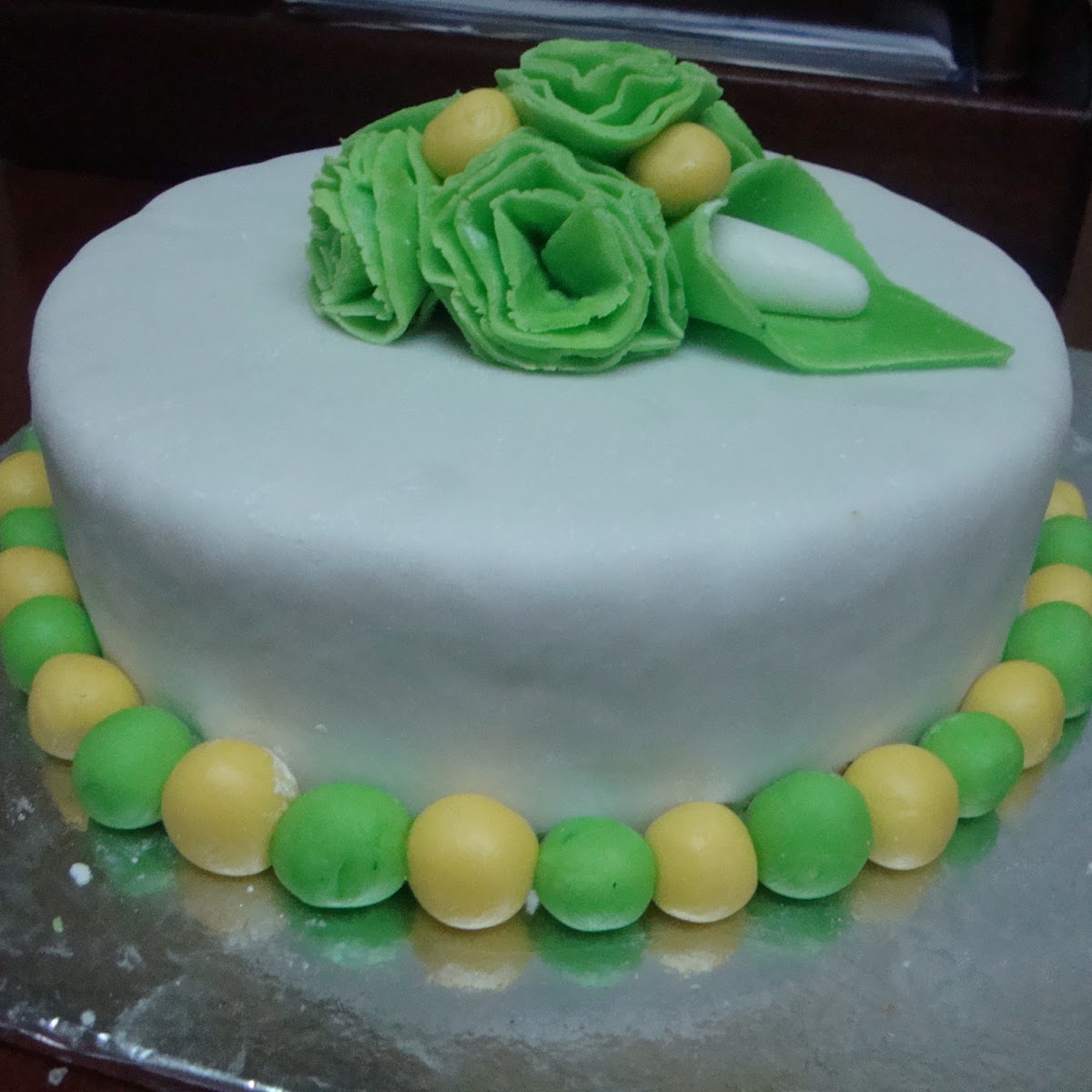 White and green tiered cake with flowers